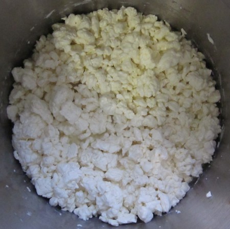 The curds after the whey has been drained. They spend another 2 hours like this being kept warm. They continue to shed whey and need to be vigorously stirred to stop them matting back together.
