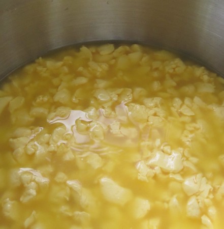 Curds at half way through the process. The whey is starting to look a lot like orange juice.